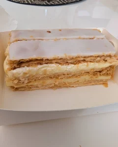 Flaky vanilla slice dessert with layers of crispy pastry and creamy custard filling