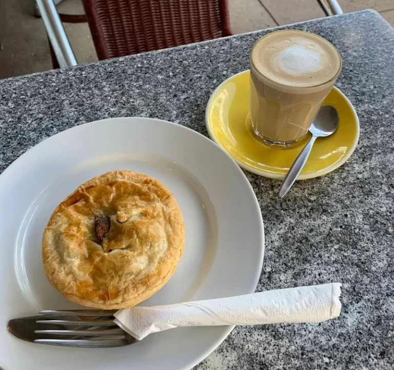 Freshly baked meat pie served with a latte at Cafe D’lish
