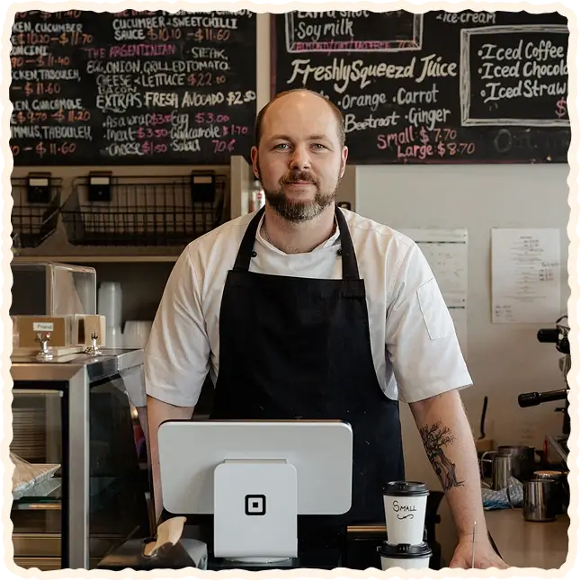 Cafe D’lish chef standing behind the counter inside the café